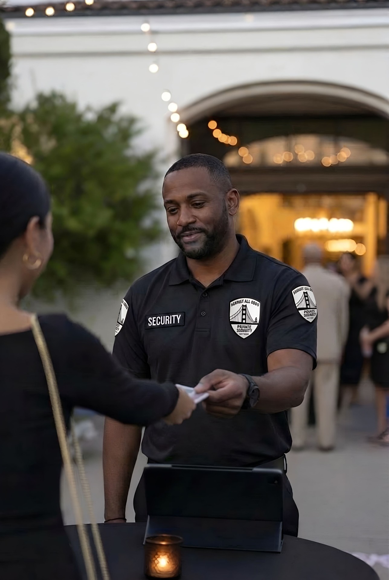 Event security officer professionally checking guest credentials at an outdoor event entrance